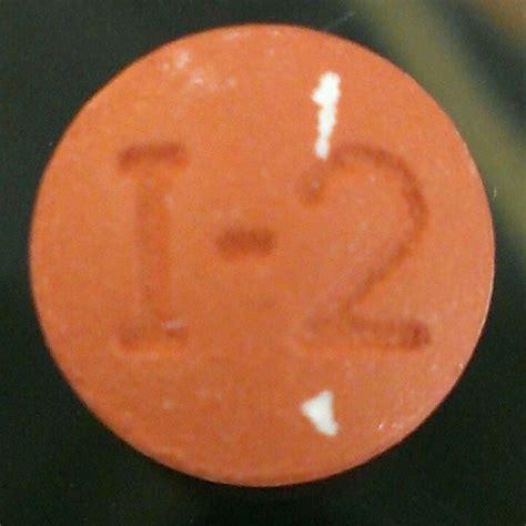 C 127. . Orange round pill 1 2
